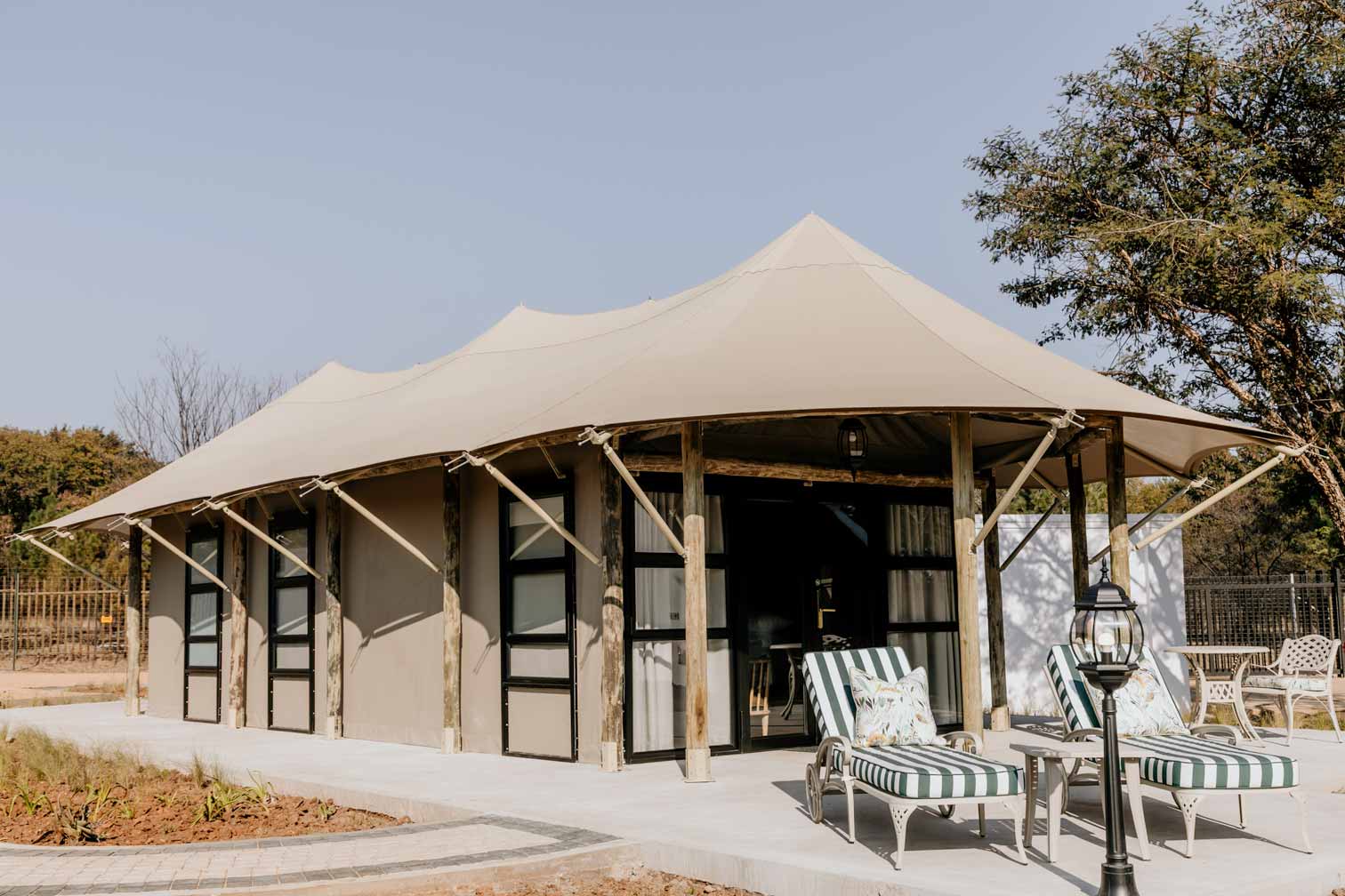 Kievits Kroon: a completed luxury tented suite with its stretch canopy, timber poles and private terrace.