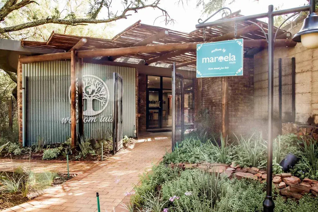Maroela Media: the office entrance with its timber pergola, corrugated cladding and welcome signage.