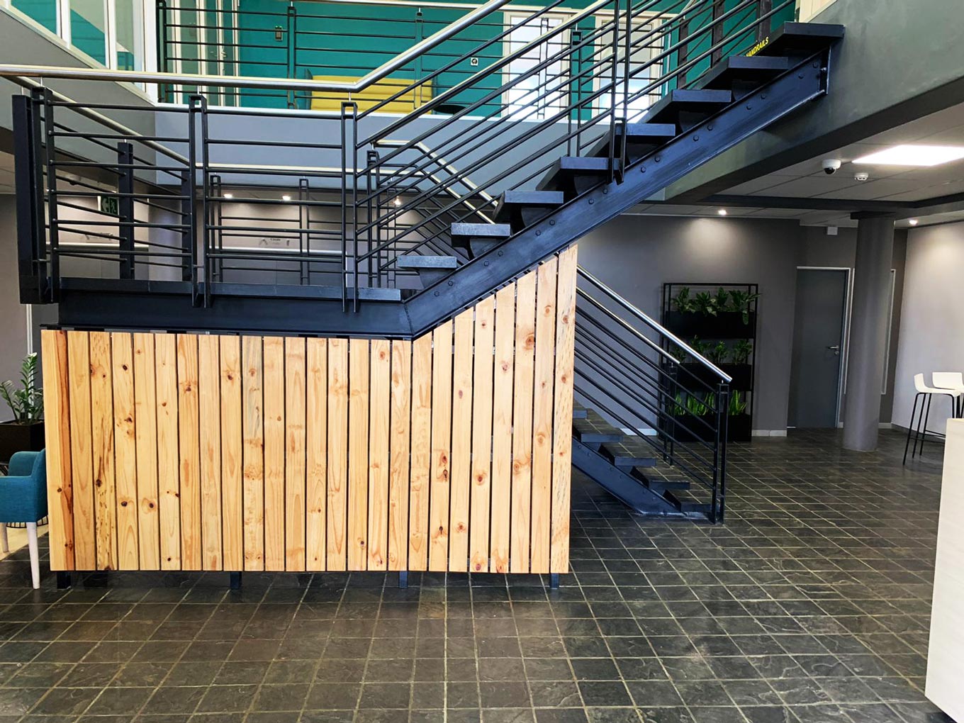 Siemens: the interior lobby with its steel staircase, pine clad reception counter and slate tile floor.